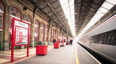 Platform with train going by at Preston Train Station