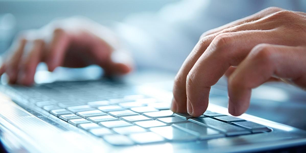 Person typing on keyboard close up