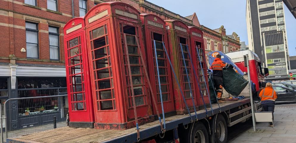 Telephone boxes loaded onto a truck