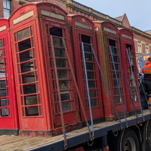 Telephone boxes loaded onto a truck